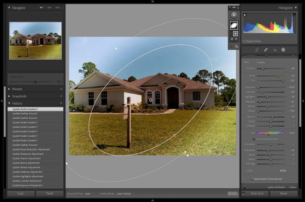 Editing an image of a white house with a brown roof and surrounded by green grass using Radial Filter in Lightroom