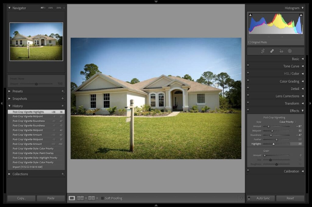 The edited image of a white house with a brown roof under the blue sky using Vignette in Lightroom