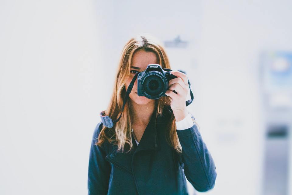 Woman taking a photo using a DSLR camera