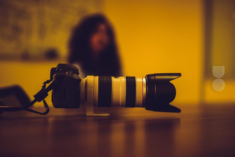 A black and white DSLR camera on a table